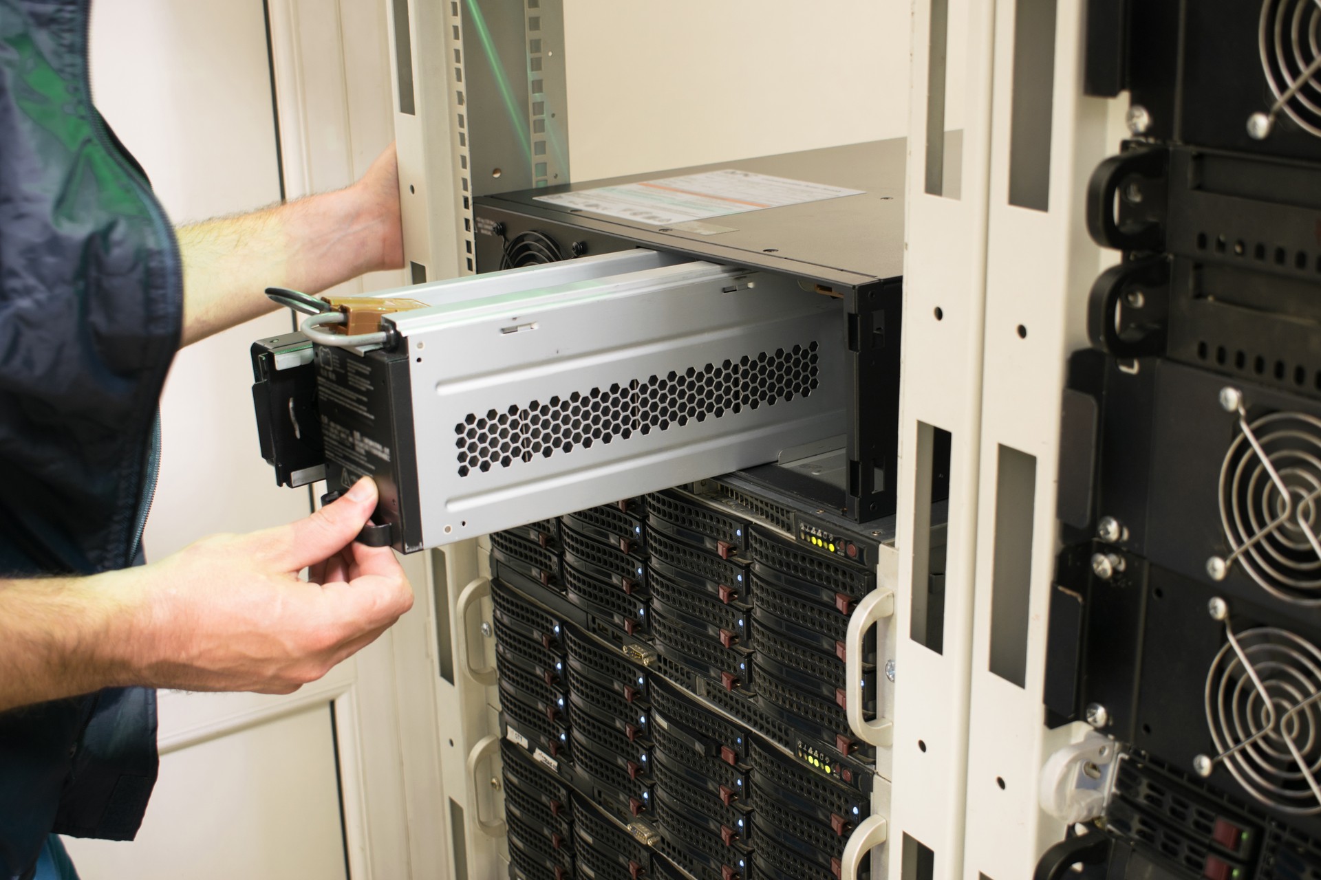 Changing the power module in the server room close-up. Working with equipment in the datacenter rack. Replacing the battery in an uninterruptible power supply.